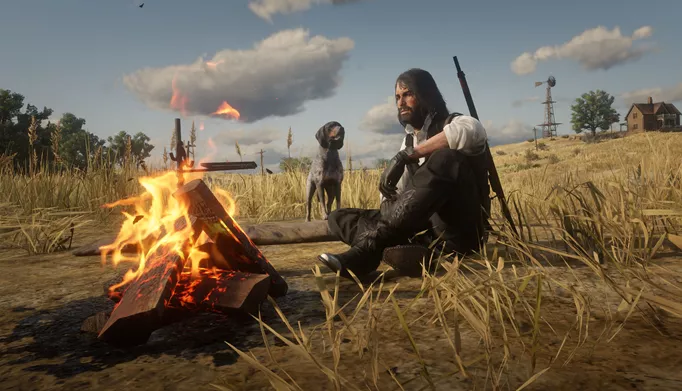 a long-haired john marston sits by a campfire with a dog next to him, looking alert