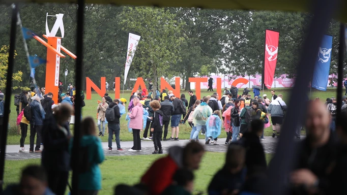 Some of the many players at Pokemon GO Fest: London 2023 in front of the "Niantic" sign