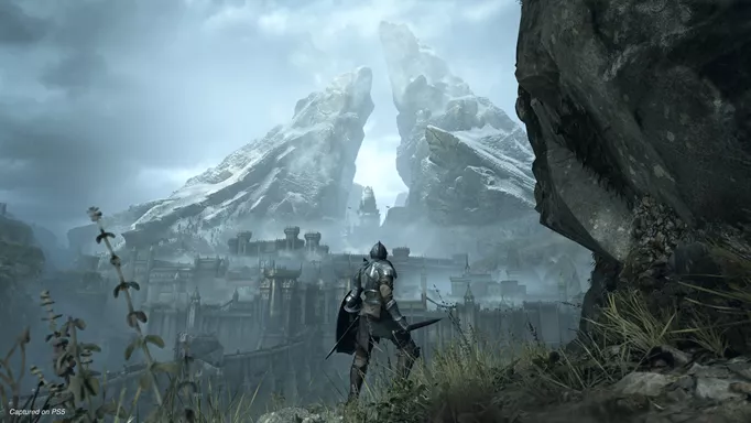 A knight looks at the landscape of a castle ahead in the Demon's Souls remake for PS5