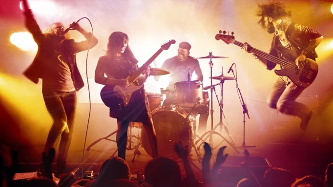 The key art for Rock band 4 featuring a live band in concert.