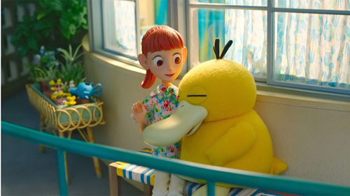 A Psyduck cuddles up to Haru in Pokemon Concierge.