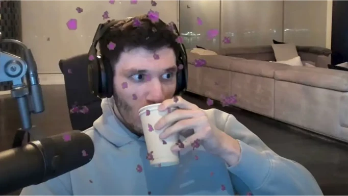 Trainwrecks sips from a cup on stream.