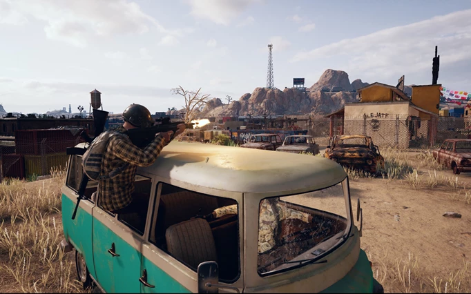 PUBG Battleground screenshot showing a player firing out of a camper van in the foreground