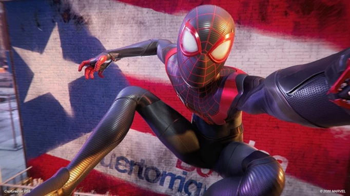 Miles Morales poses in front of a Puerto Rican flag in Marvel's Spider-Man: Miles Morales.