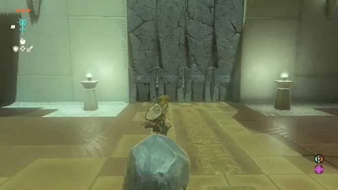 Link walking towards a breakable wall with a boulder fused to his weapon