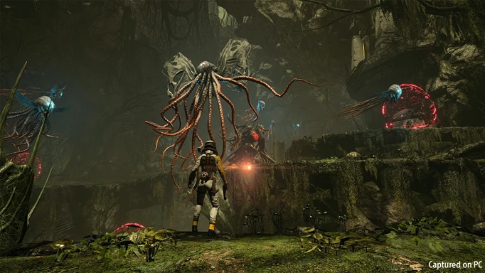 Screenshot of combat with a tentacle alien in Returnal