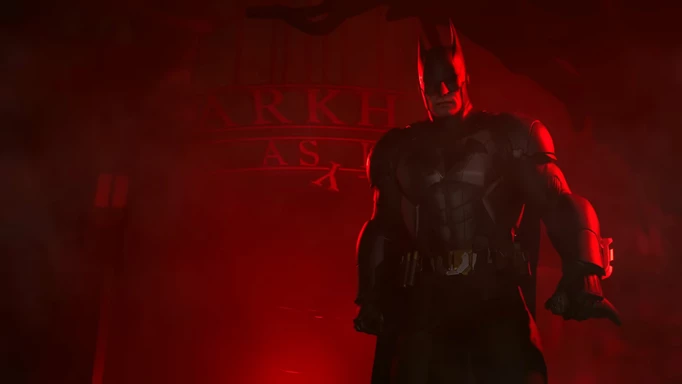 Batman in a red room in front of the Arkham Asylum sign