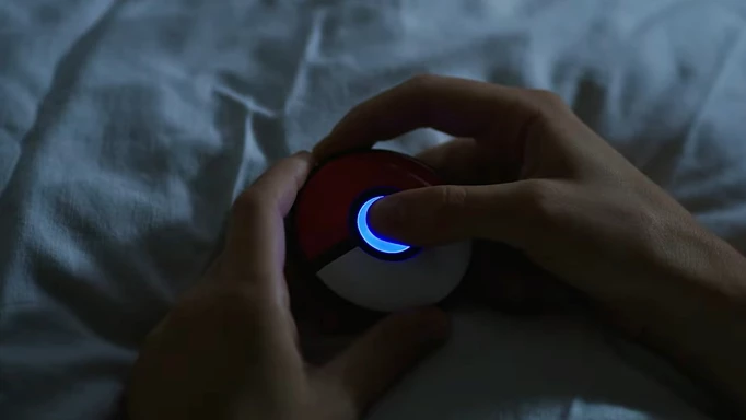 Pressing and holding the main button, the first step in how to track sleep with Pokemon GO Plus +