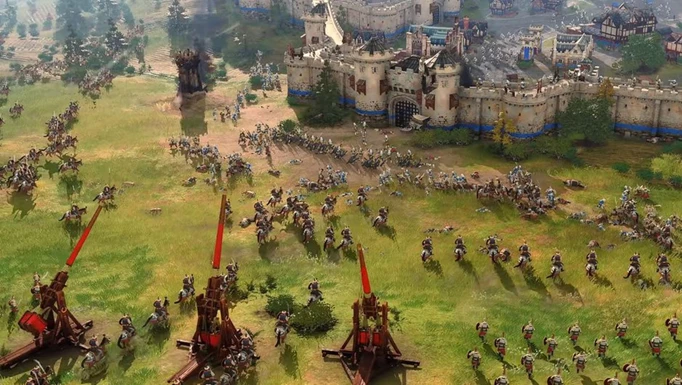 A battle takes place in Age of Empires IV, with catapults and horses charging toward a castle under siege