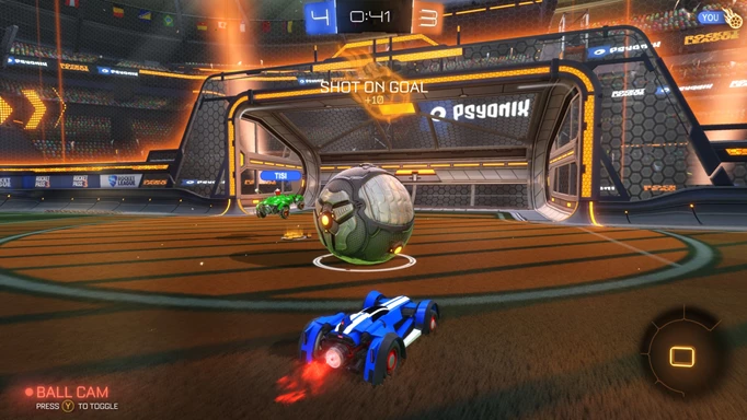 A gameplay screenshot from Rocket League of a player taking a shot on goal