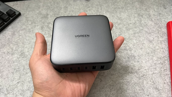 Ugreen Nexode charger in a reviewer's hand