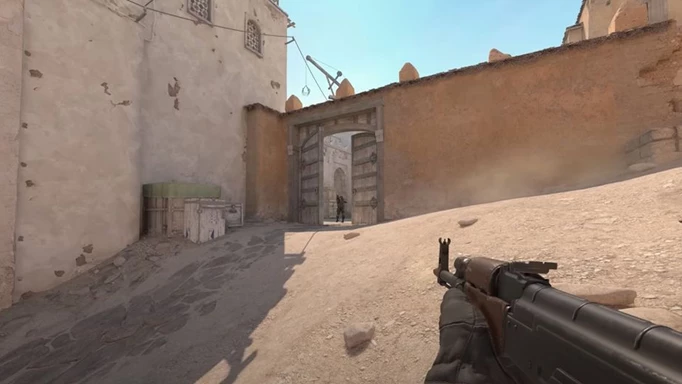 Counter Strike 2 patch notes: A player wielding an AK47 approaching a door on Dust 2