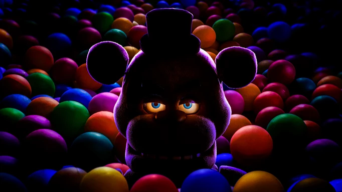 Key art for the Five Nights at Freddy's movie, featuring Freddy peeking out of a ballpit.