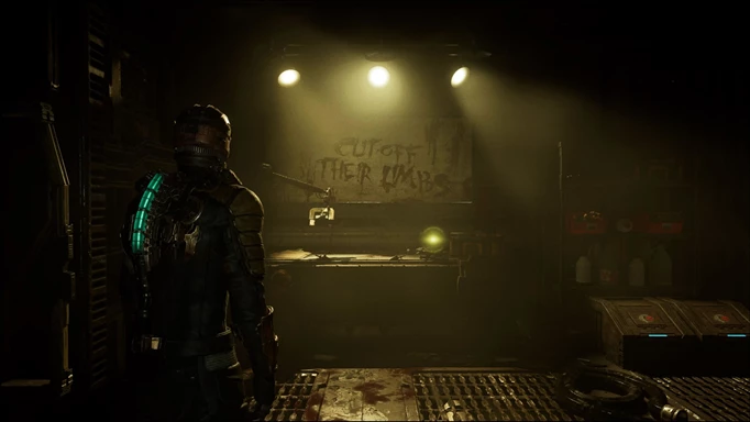 Isaac Clarke stares at a message telling him to "CUT OFF THEIR LIMBS" in the Dead Space Remake