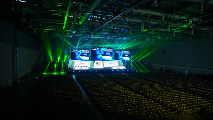 Overwatch League Mid Season Madness stage prior to the action starting. The arena is still empty and green light rays are flashing.