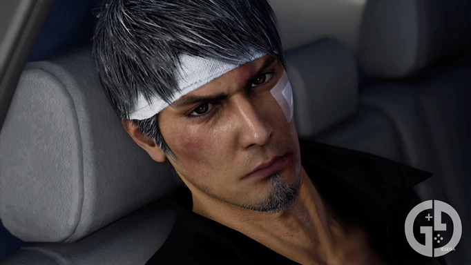 Kiryu with several bandages on his face, sitting in the back of a car
