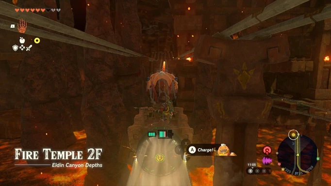 Link rides the rails in a mine crat with Yunobo ready to charge in Zelda: Tears of the Kingdom