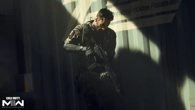 Key art of MW2 where a character is in the shadows stood against a container